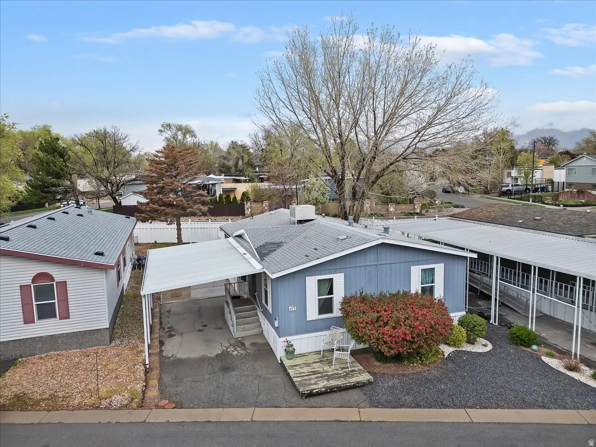 View of building exterior with a residential view and asphalt driveway
