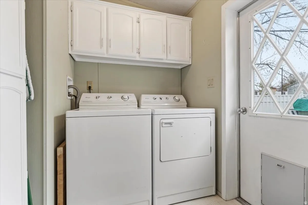 Laundry room with cabinet space and washing machine and dryer
