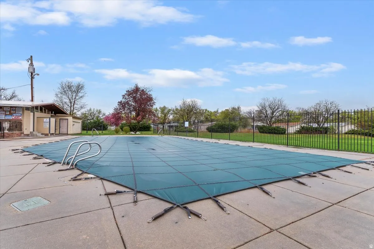Community pool with a patio