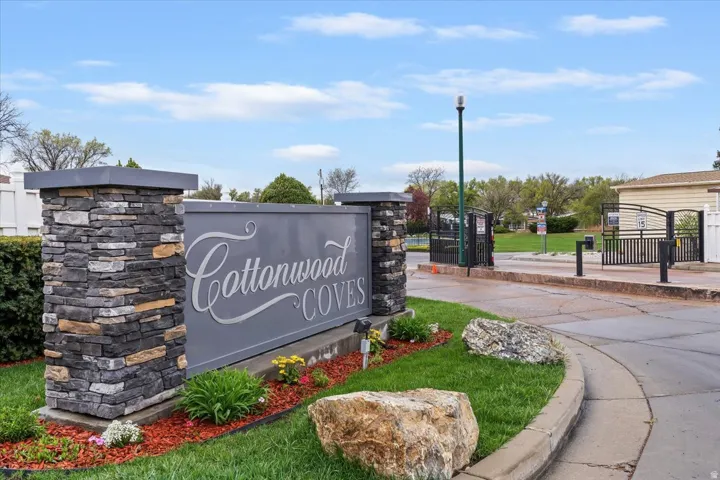 Community / neighborhood sign featuring a gate