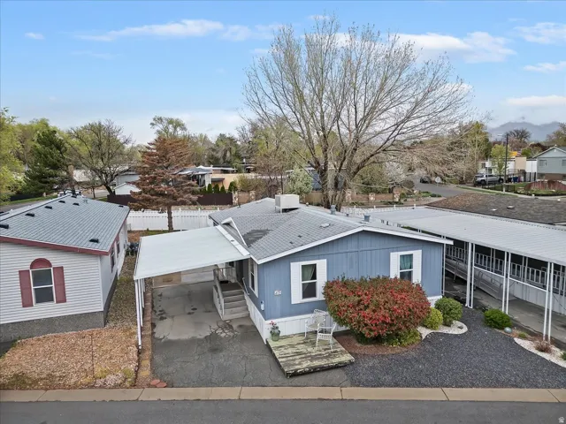 View of building exterior with a residential view and asphalt driveway