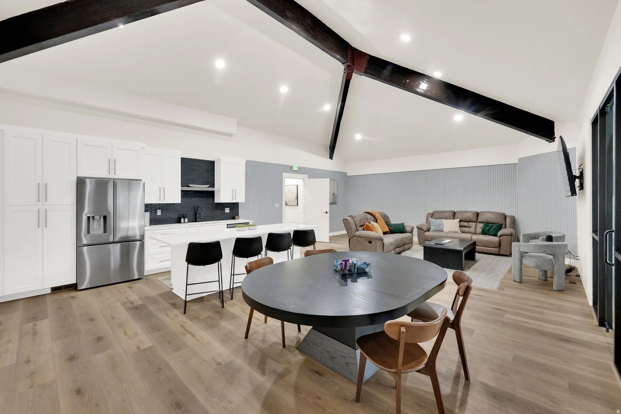 Dining space with light wood-style floors and lofted ceiling