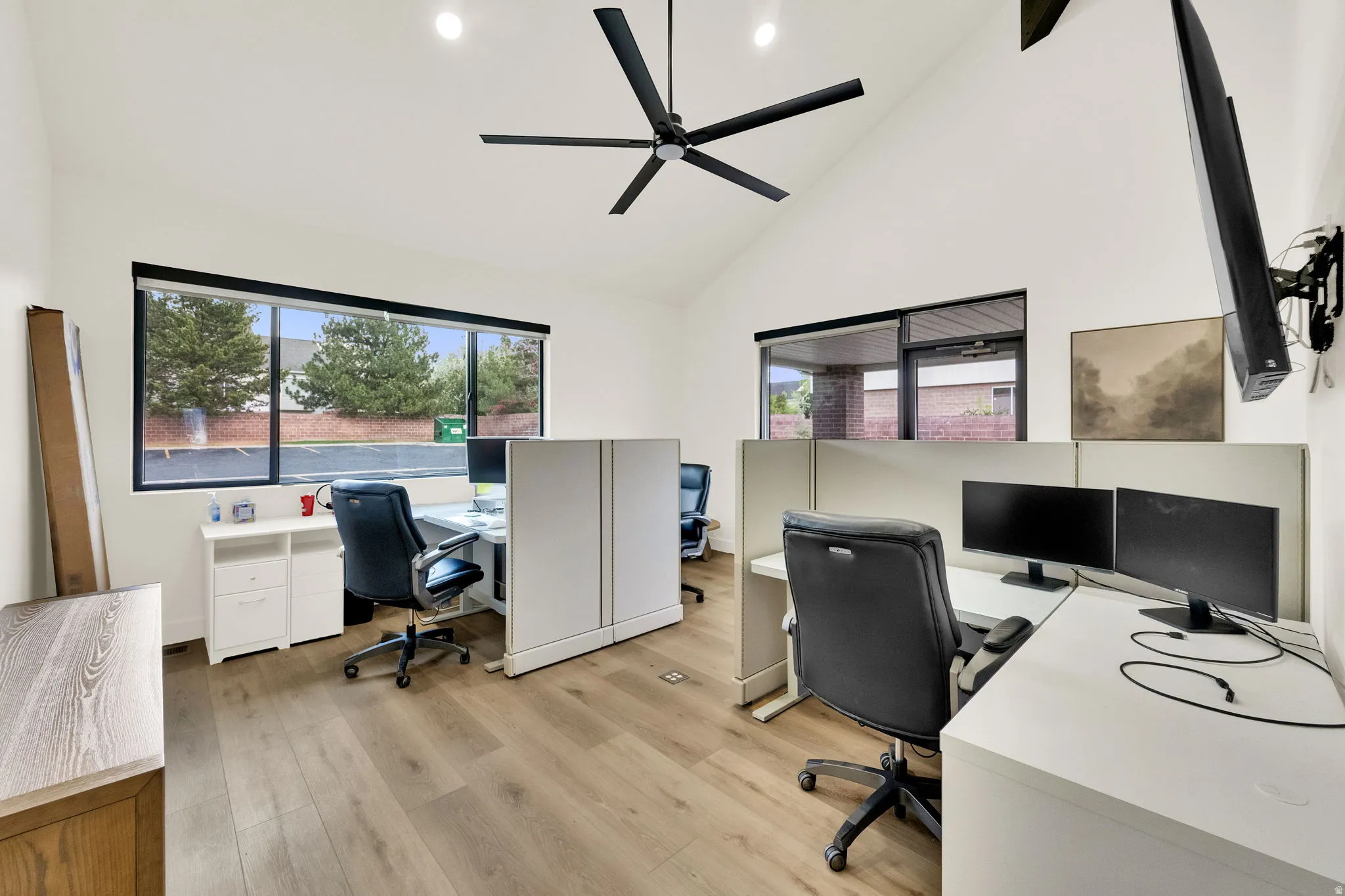 Office with light wood-type flooring, recessed lighting, lofted ceiling, and a ceiling fan