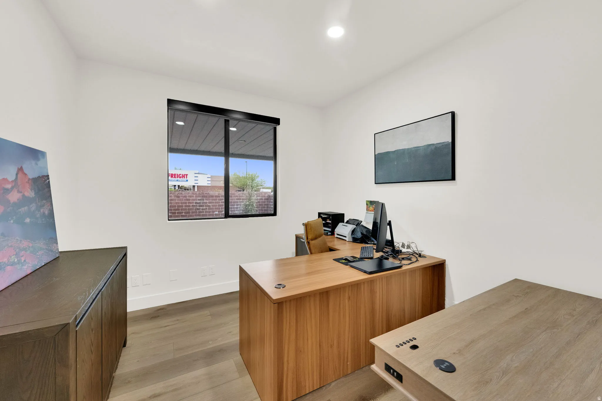 Office space featuring light wood-style floors and recessed lighting