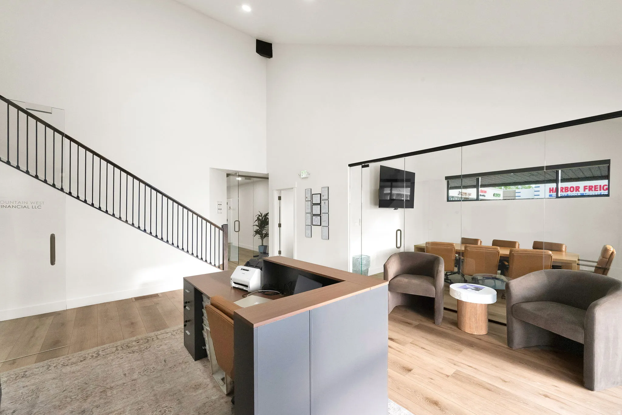 Living room featuring light wood finished floors and a high ceiling