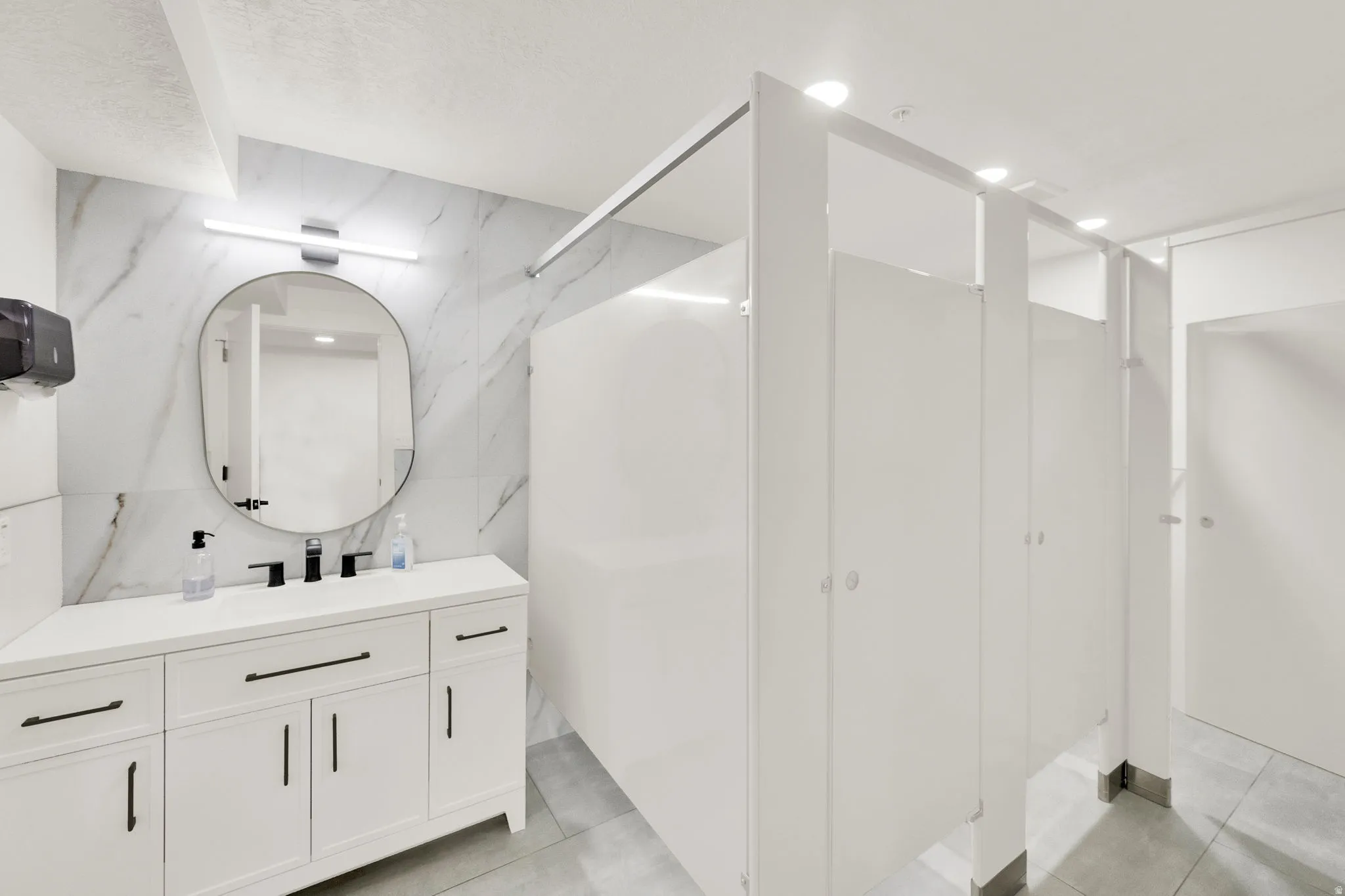 Bathroom with vanity, tile walls, and a closet