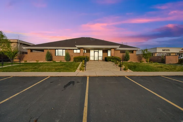 View of property with uncovered parking