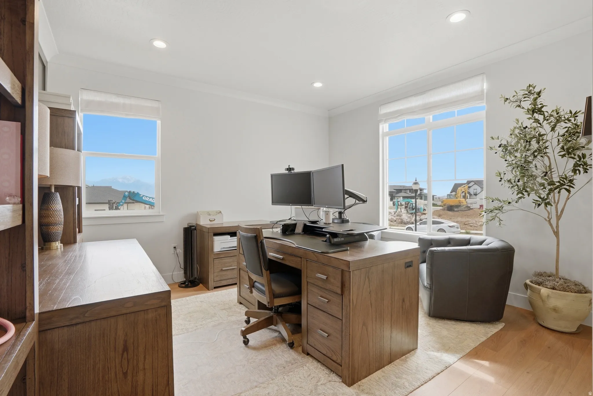 Office space with light wood-style flooring, crown molding, and recessed lighting