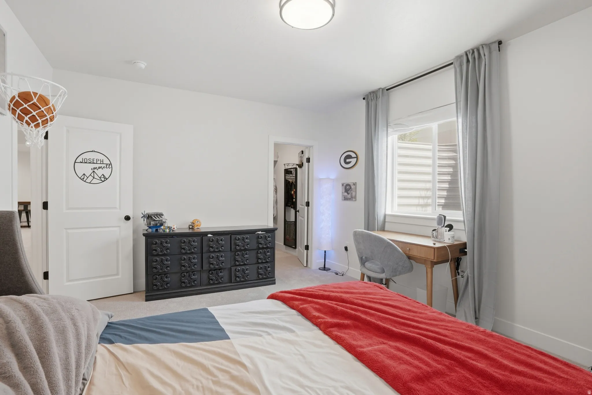 Bedroom featuring a spacious closet and light colored carpet