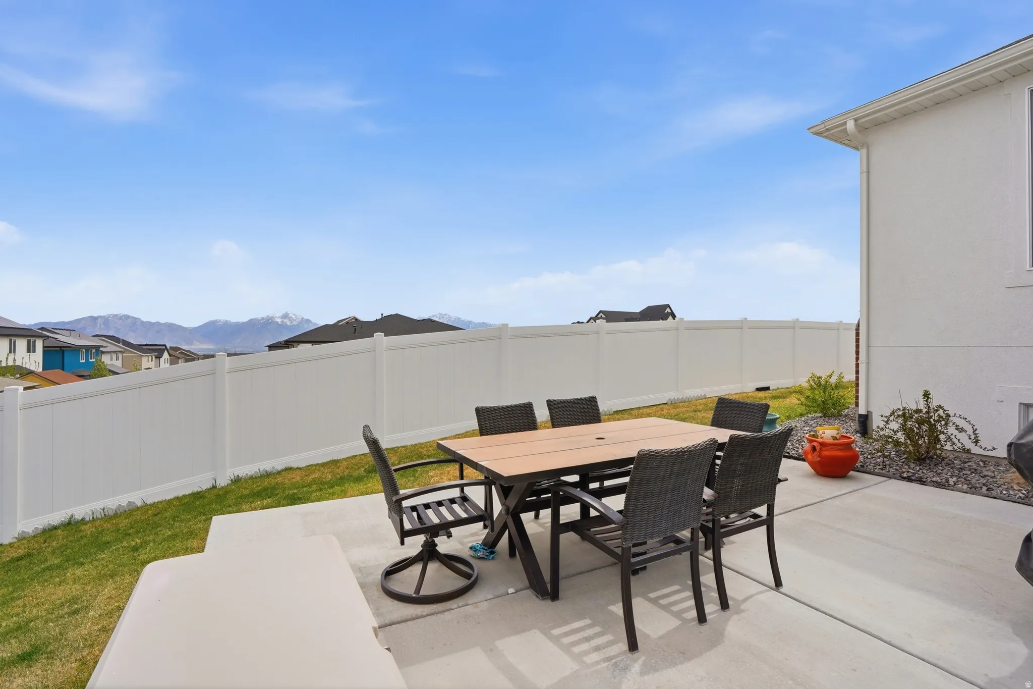 Fenced backyard featuring outdoor dining area, a patio area, and a mountain view