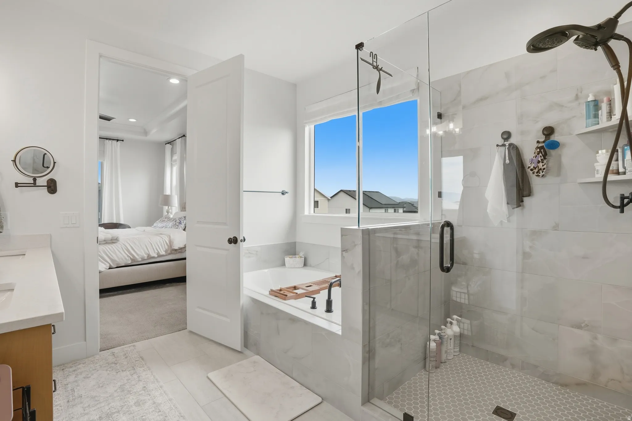 Bathroom featuring vanity, a garden tub, a shower stall, light colored carpet, and ensuite bath