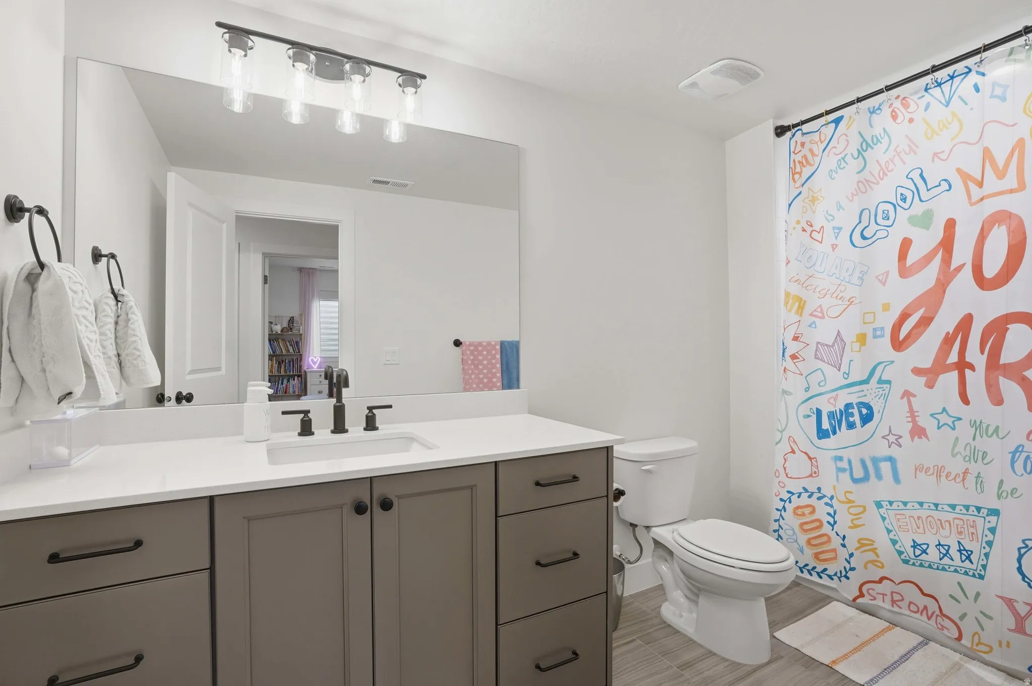 Bathroom featuring vanity and a shower with shower curtain