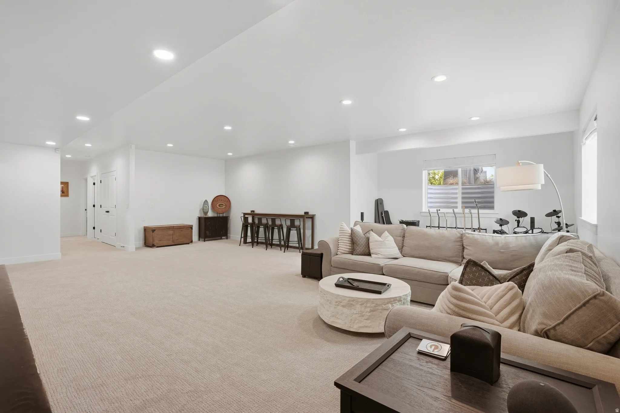 Living area featuring light carpet and recessed lighting