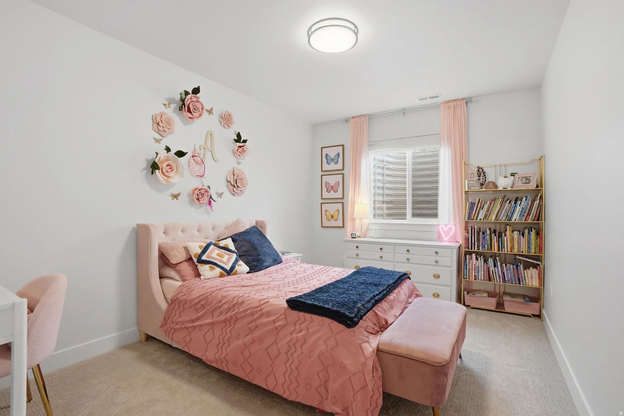 Bedroom featuring light colored carpet