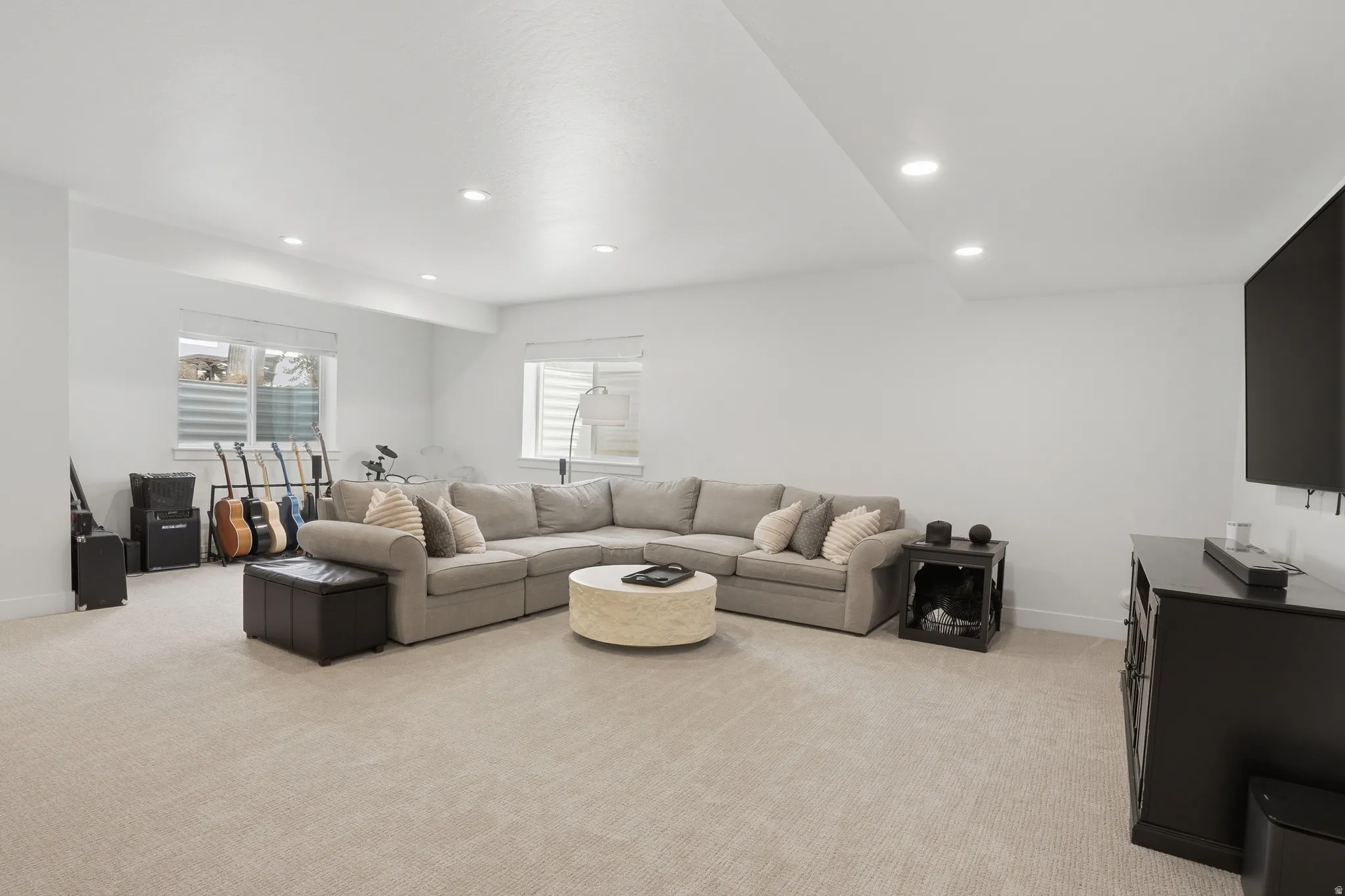 Living room with light carpet and recessed lighting