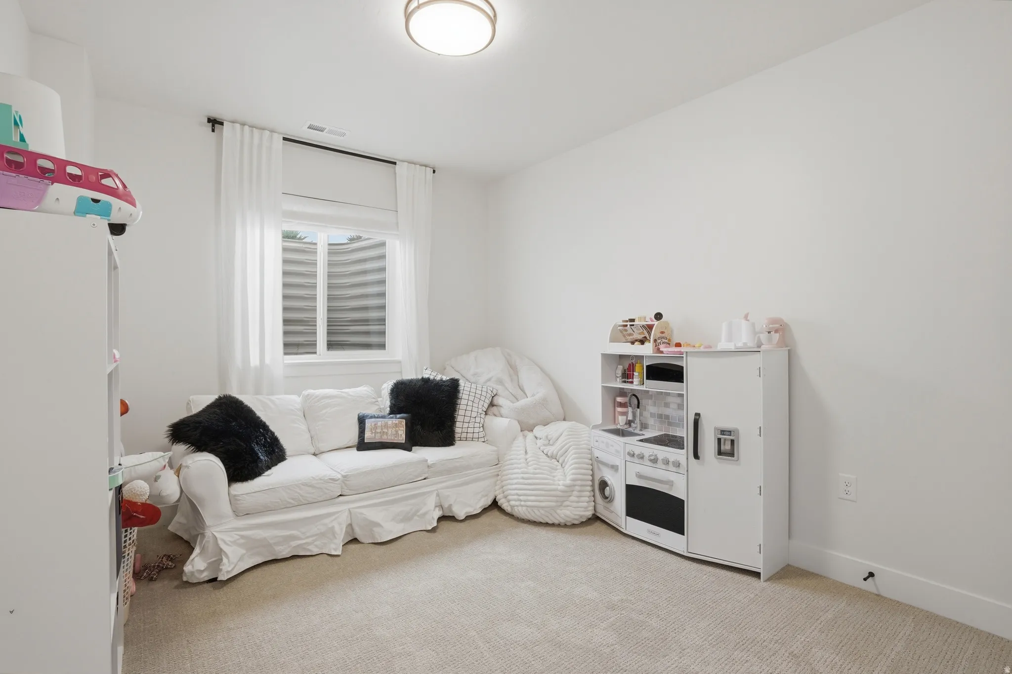 Playroom featuring light carpet and baseboards
