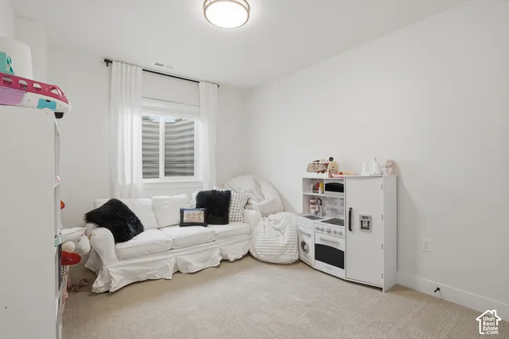 Playroom featuring light carpet and baseboards