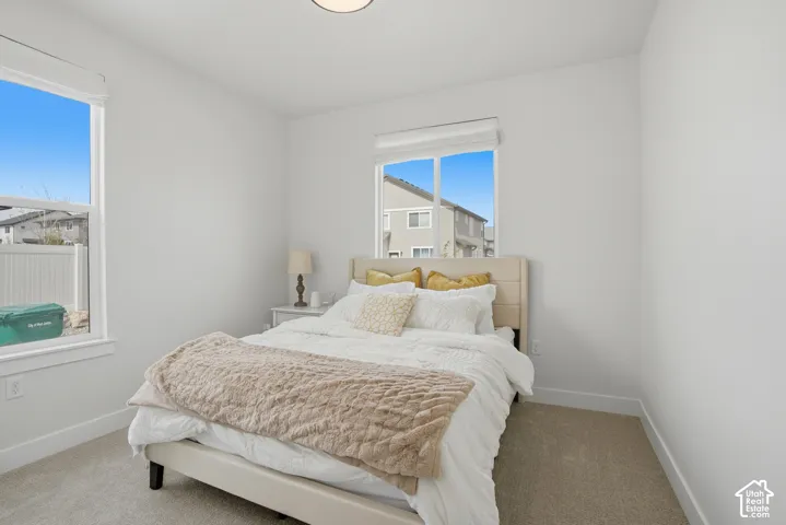 Carpeted bedroom featuring baseboards