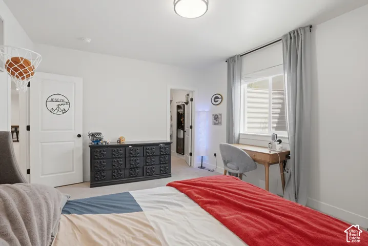 Bedroom featuring a spacious closet and light colored carpet
