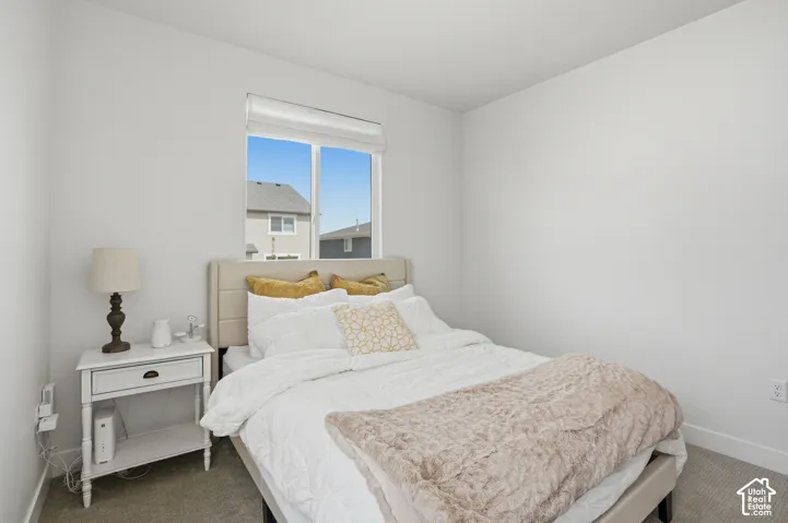 Carpeted bedroom with baseboards