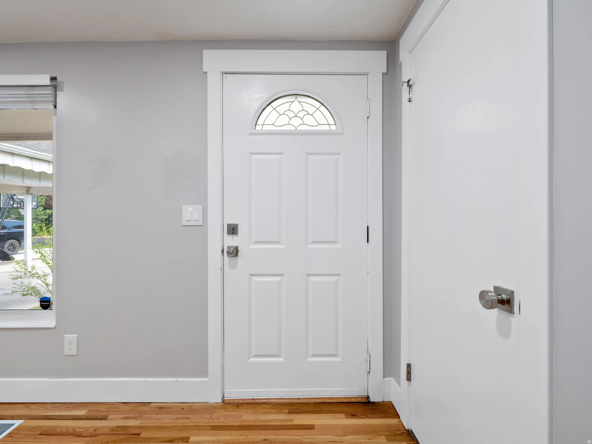 Foyer entrance featuring light wood-style flooring and plenty of natural light