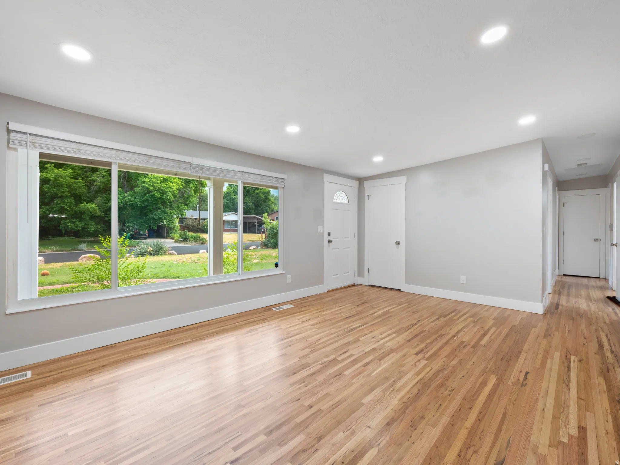 Unfurnished living room with light wood-style floors and recessed lighting