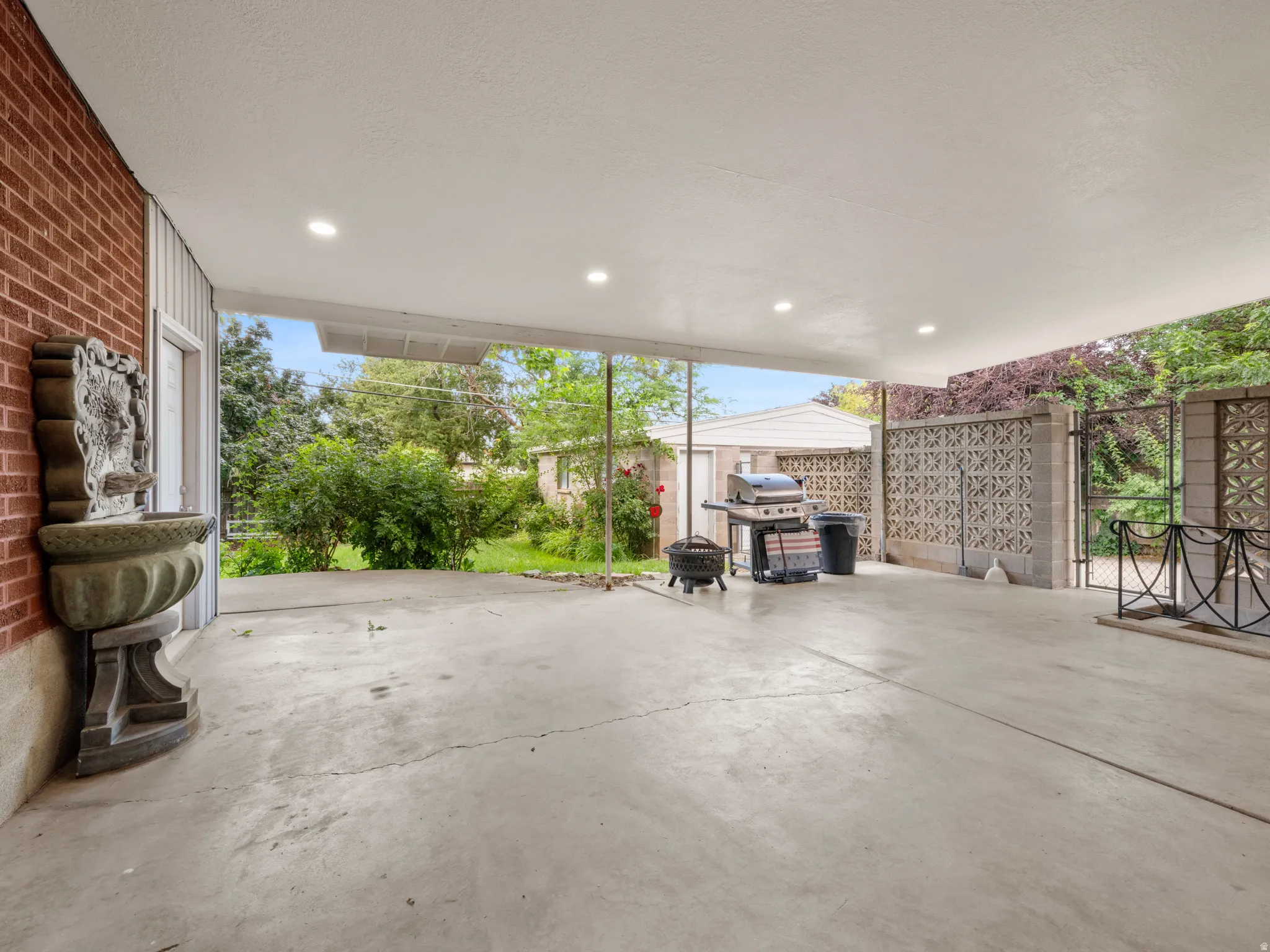 View of patio featuring a grill and an outdoor structure