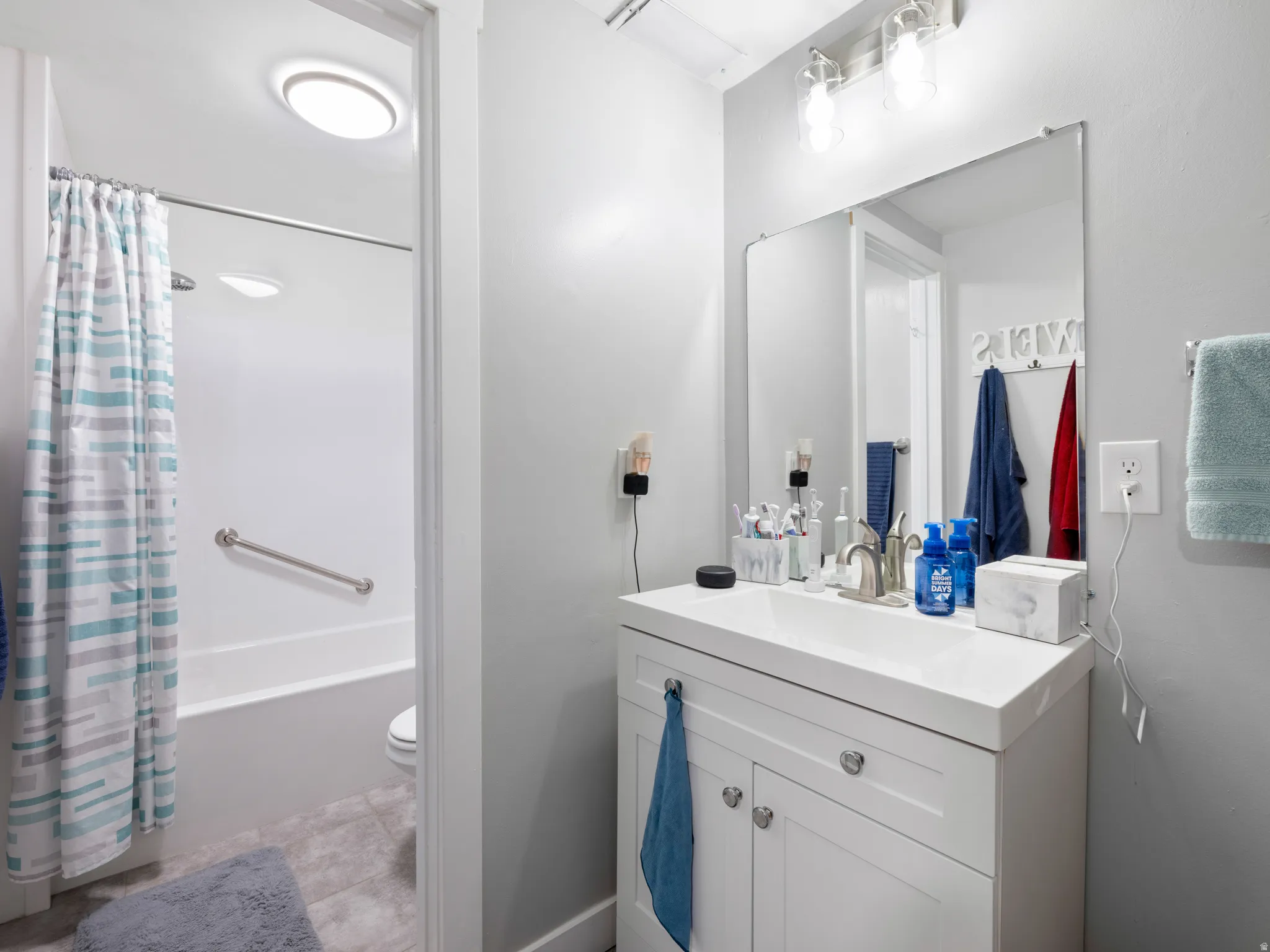 Bathroom featuring vanity and shower / tub combo