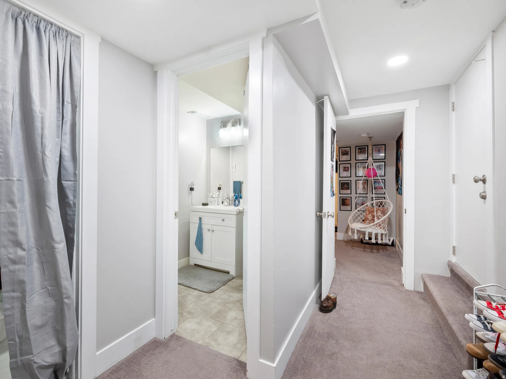 Corridor featuring light colored carpet and recessed lighting