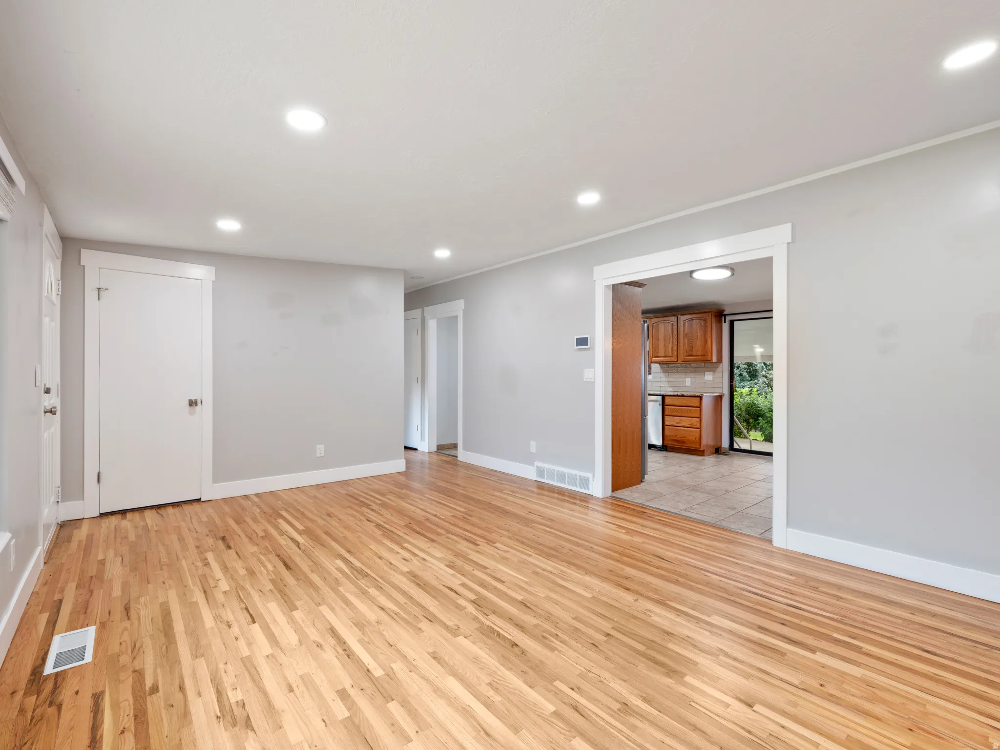 Unfurnished living room featuring light wood finished floors and recessed lighting