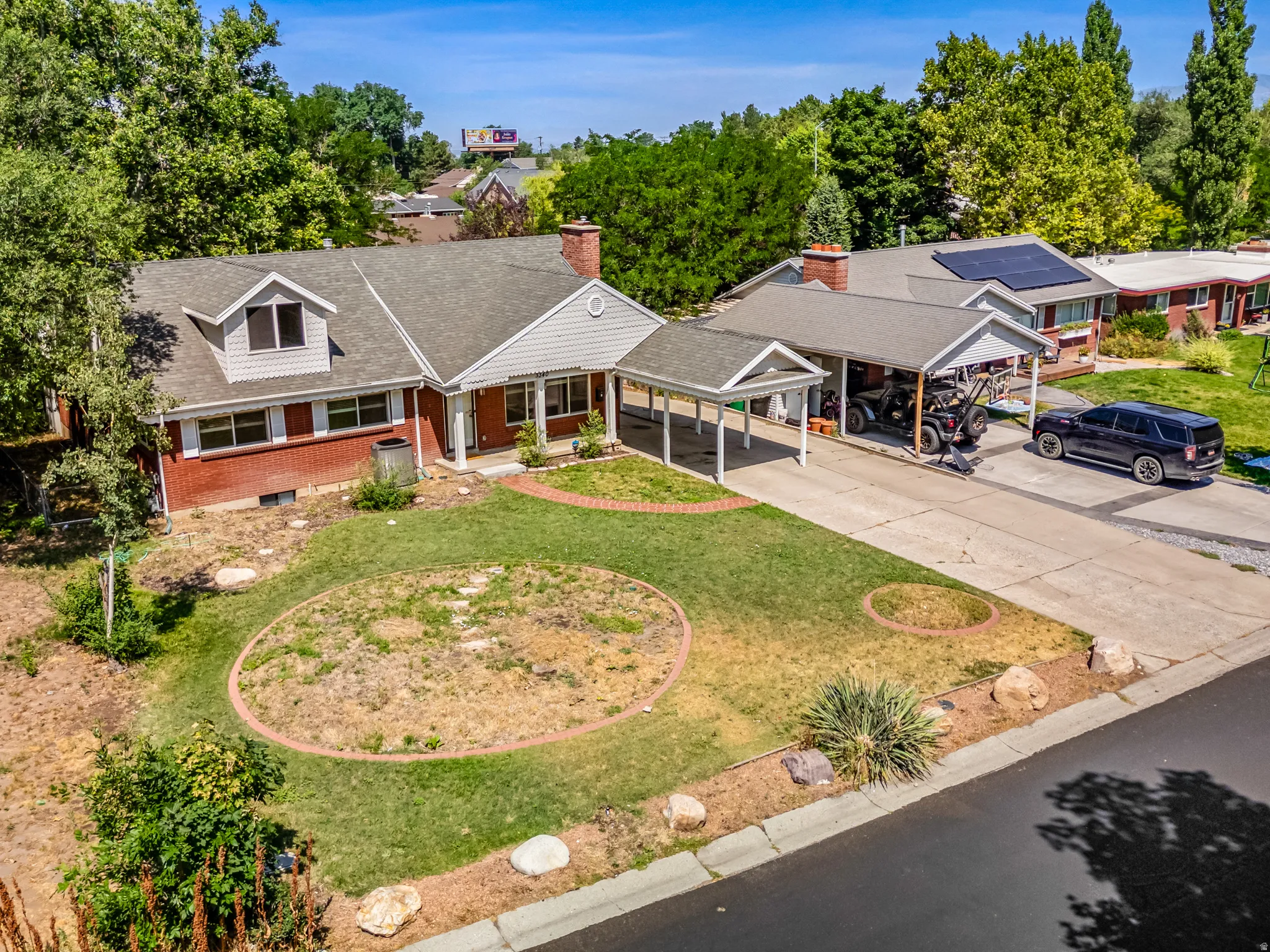 View from above of property featuring a tree filled landscape