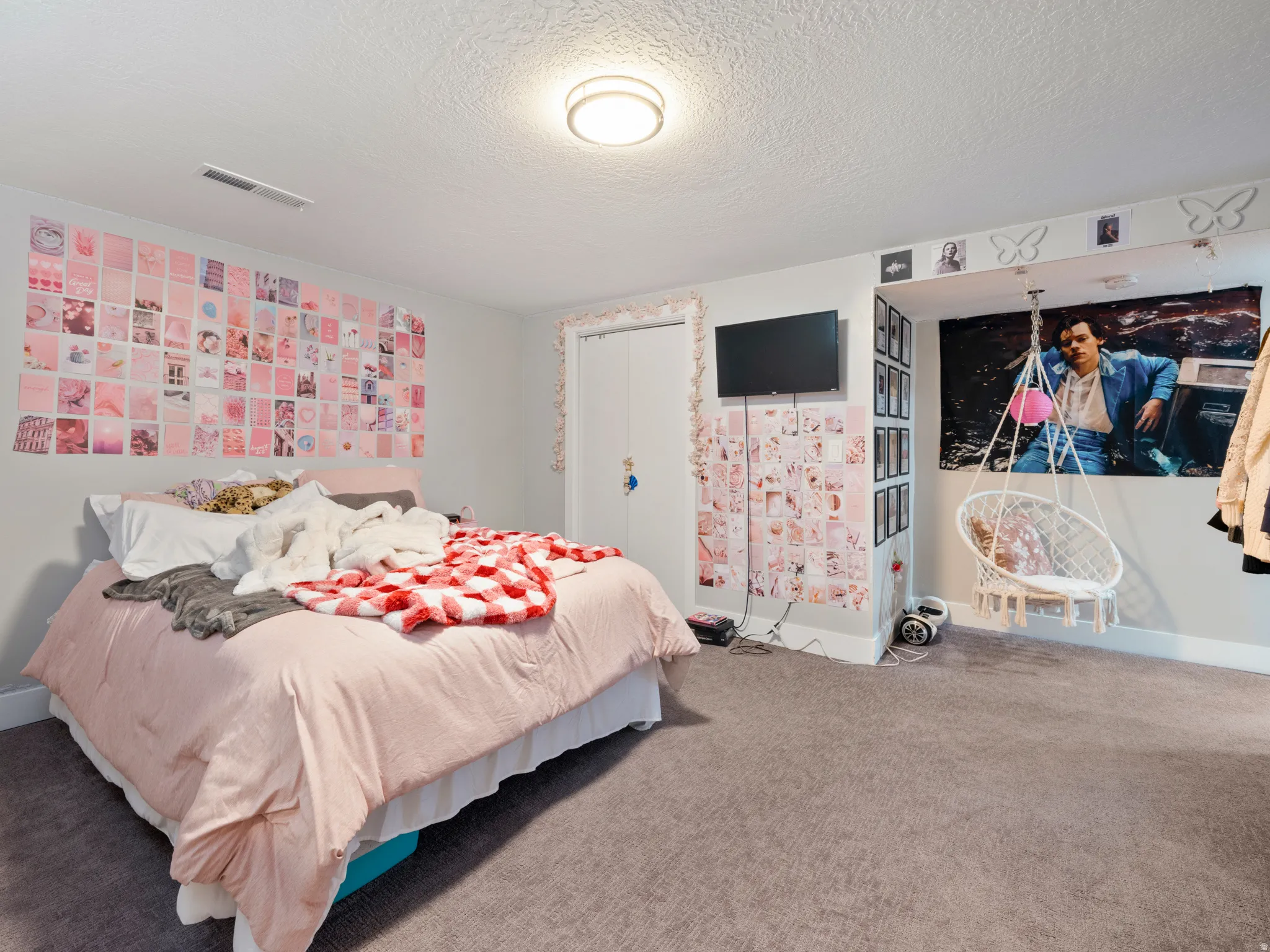Bedroom featuring carpet and a textured ceiling