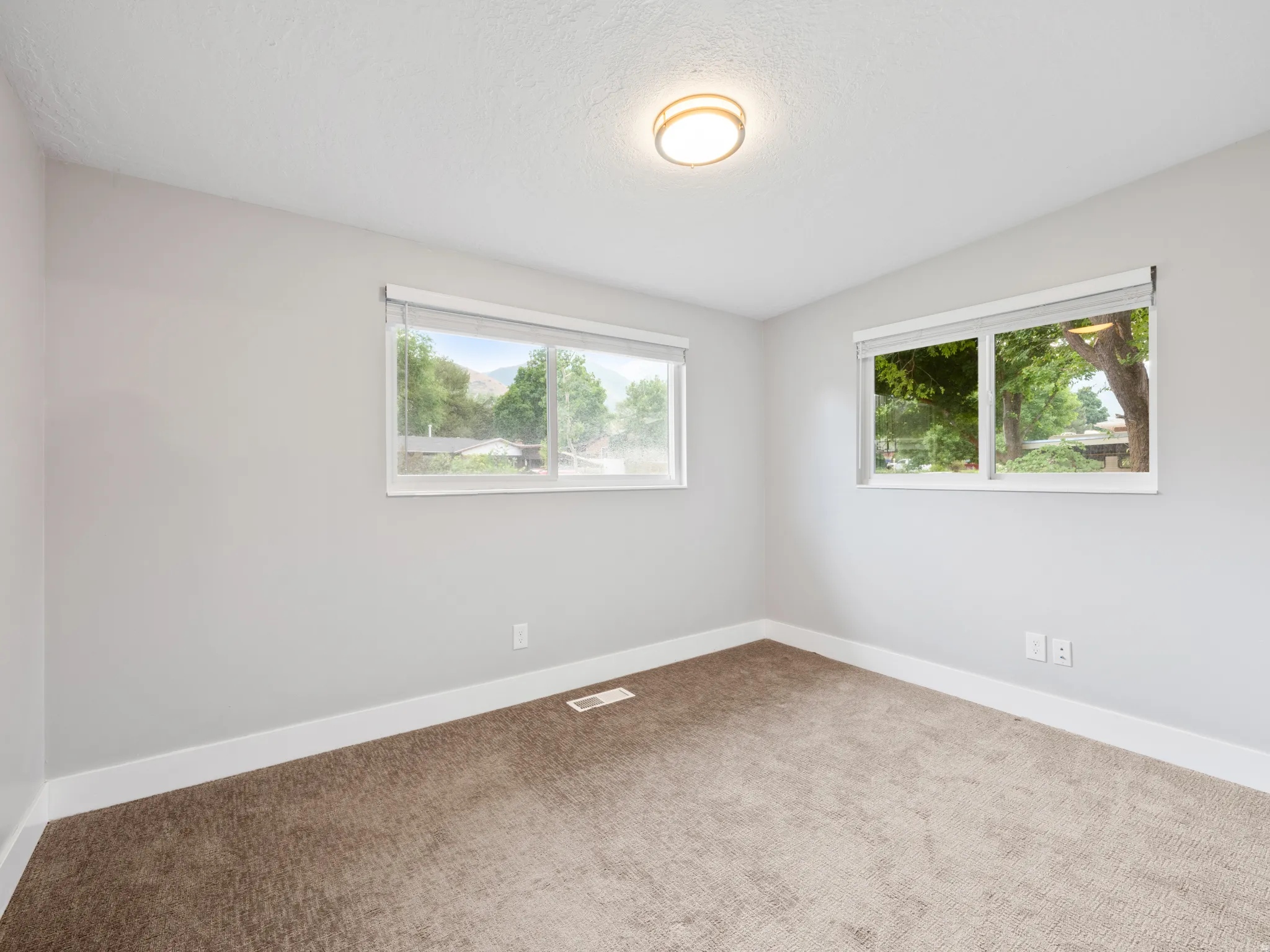 Empty room with baseboards and carpet floors