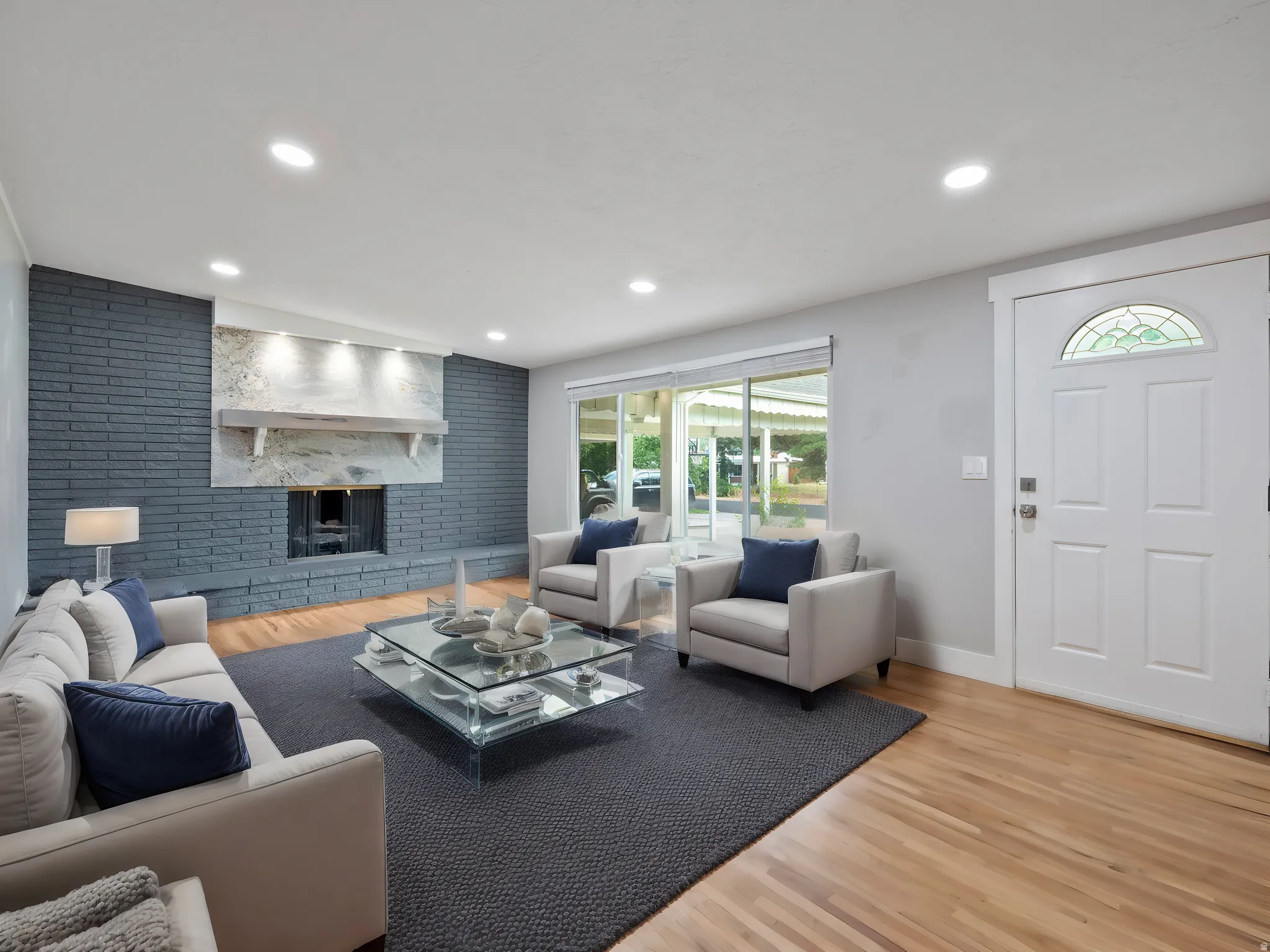 Living room with light wood-type flooring, a fireplace, and recessed lighting