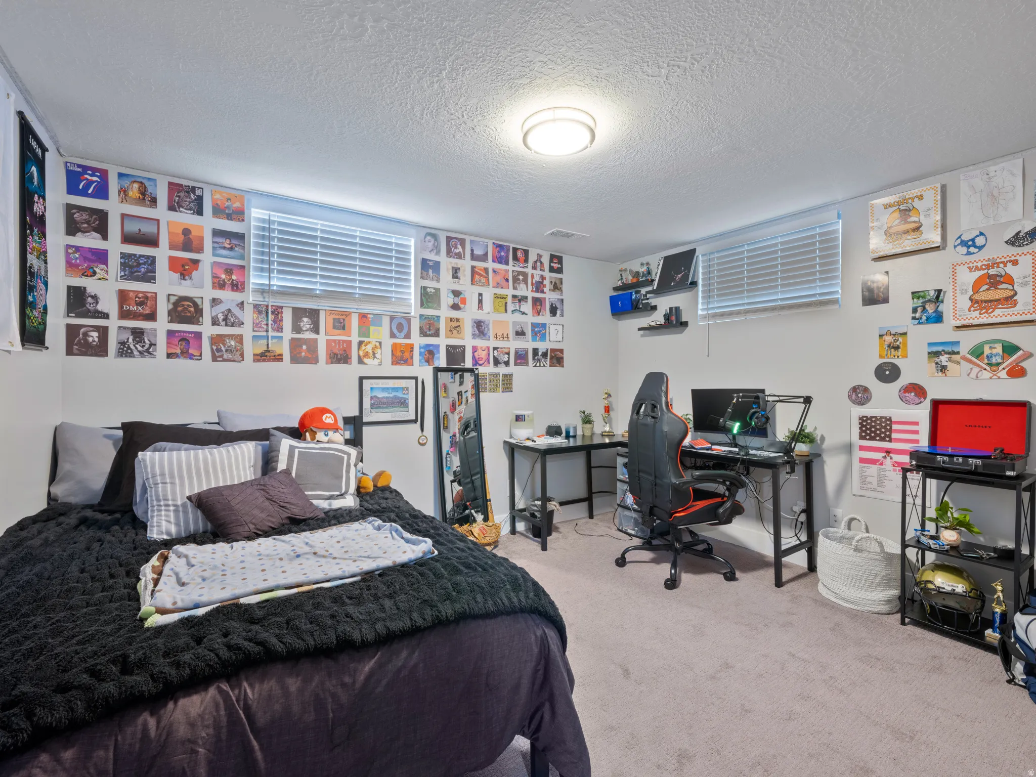 Bedroom featuring carpet floors, a textured ceiling, and an office area
