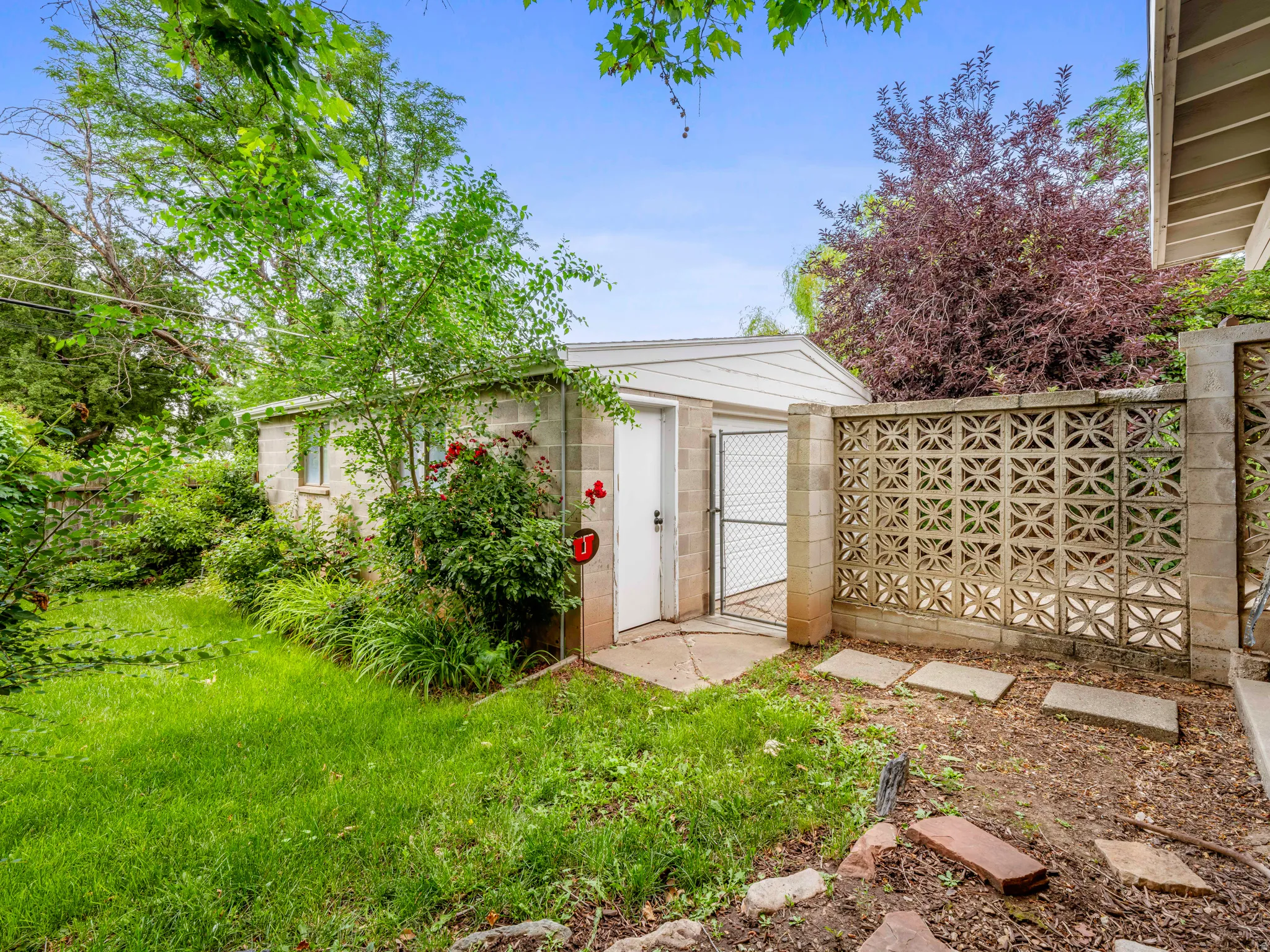 View of outbuilding featuring a gate