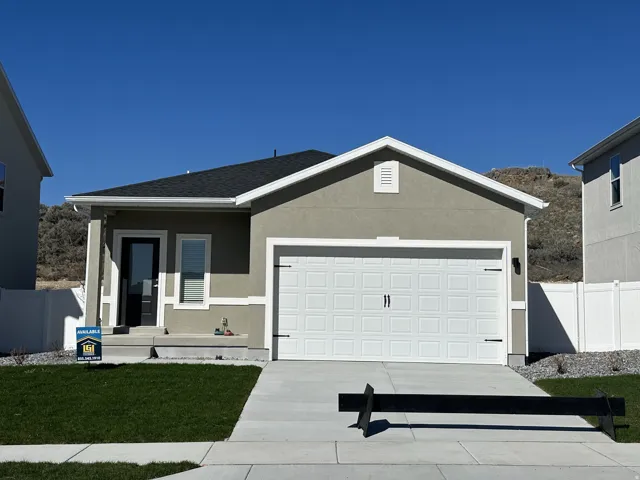 Ranch-style house with stucco siding, an attached garage, a porch, driveway, and a shingled roof