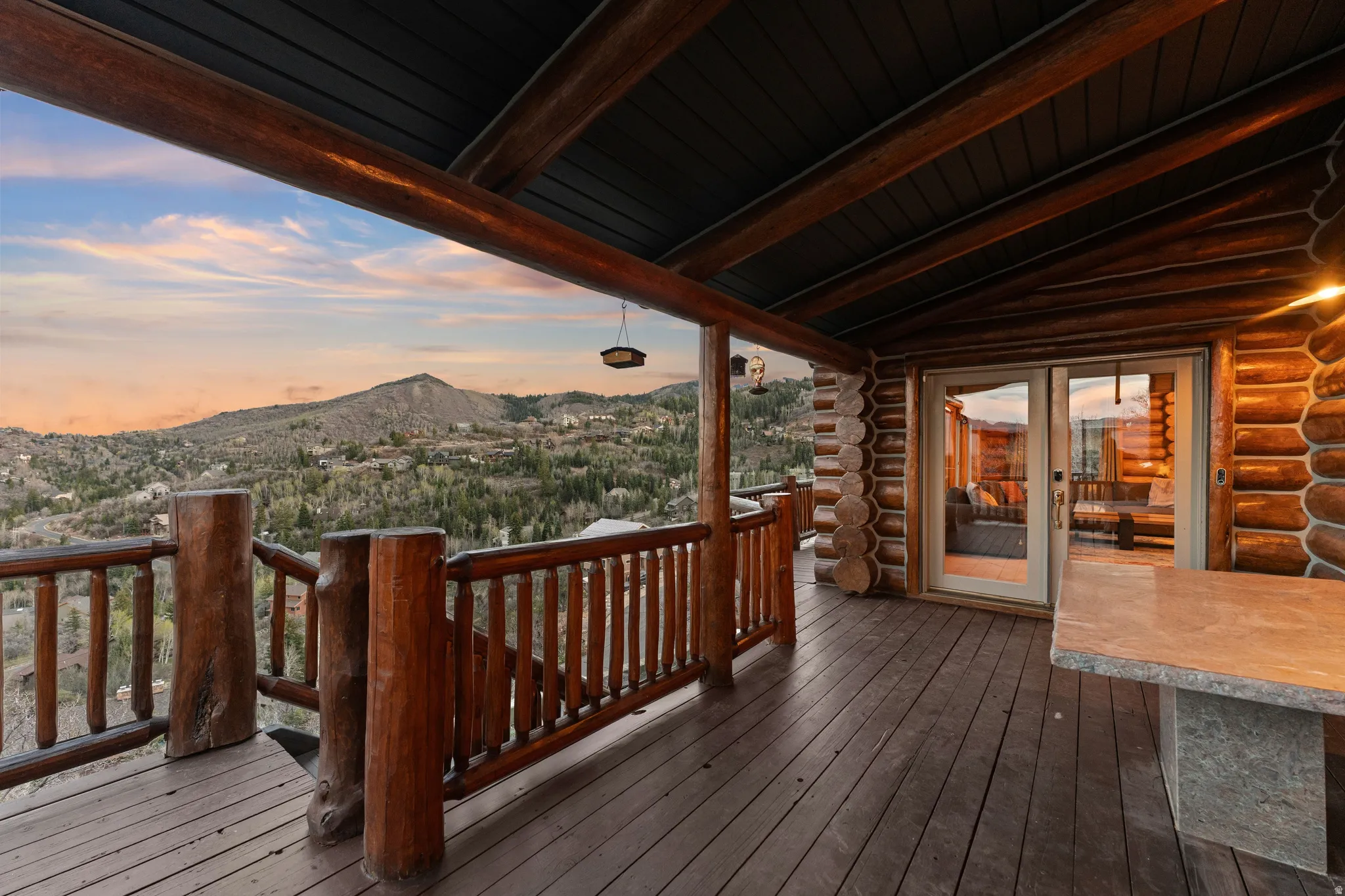 Wooden deck with a mountain view and french doors