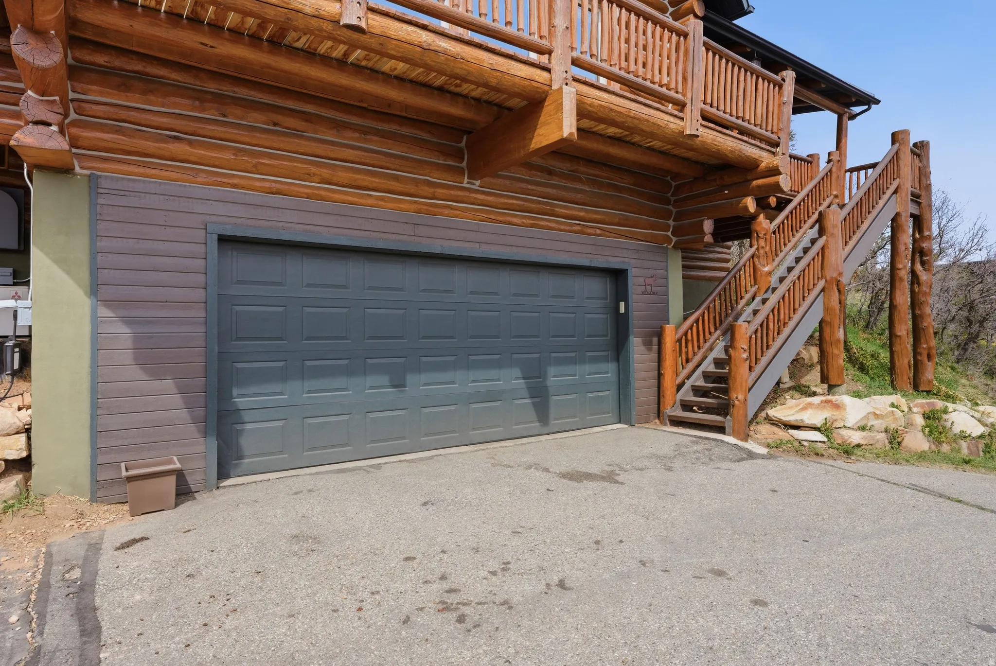 Garage featuring asphalt driveway
