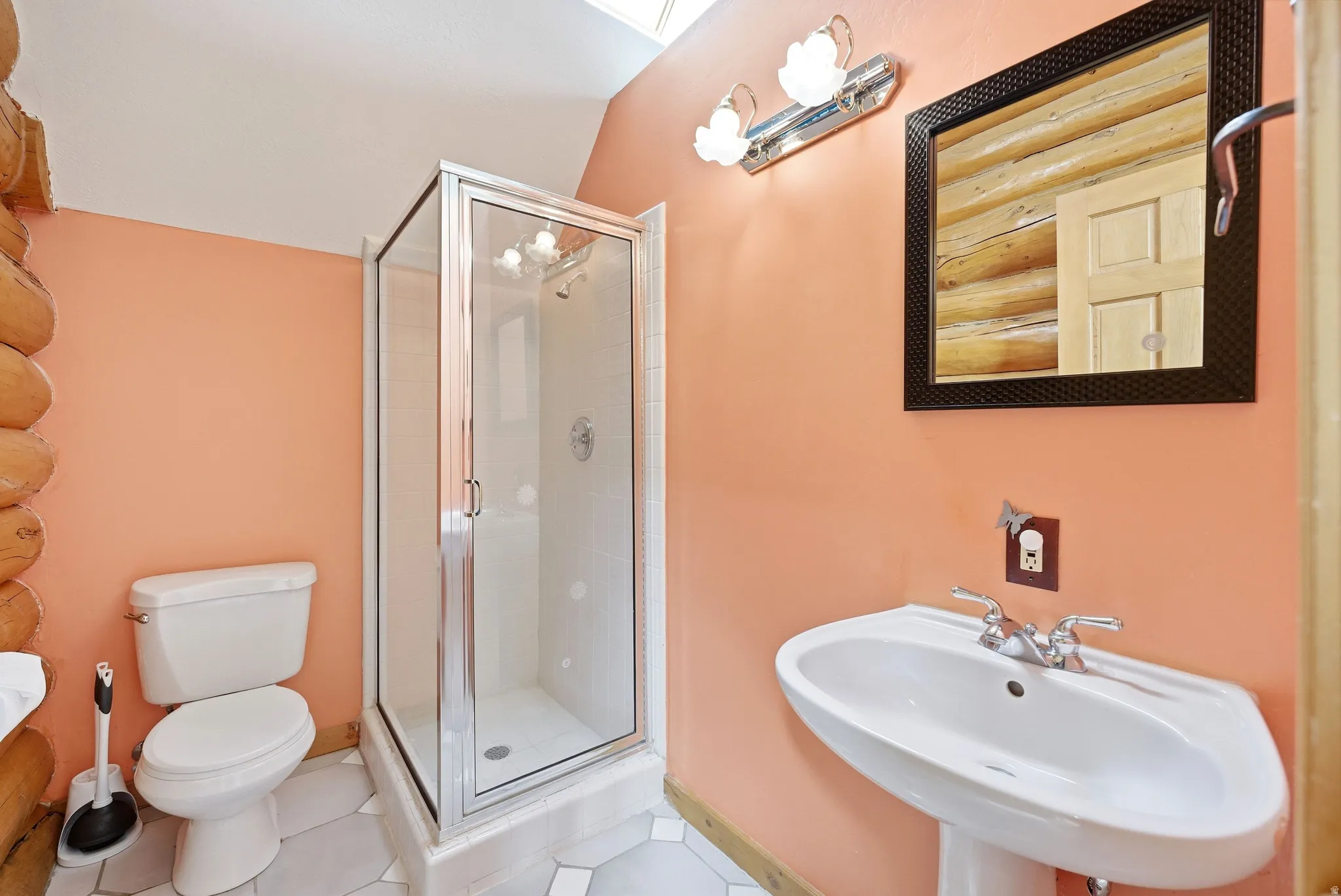 Bathroom featuring a stall shower and light tile patterned flooring