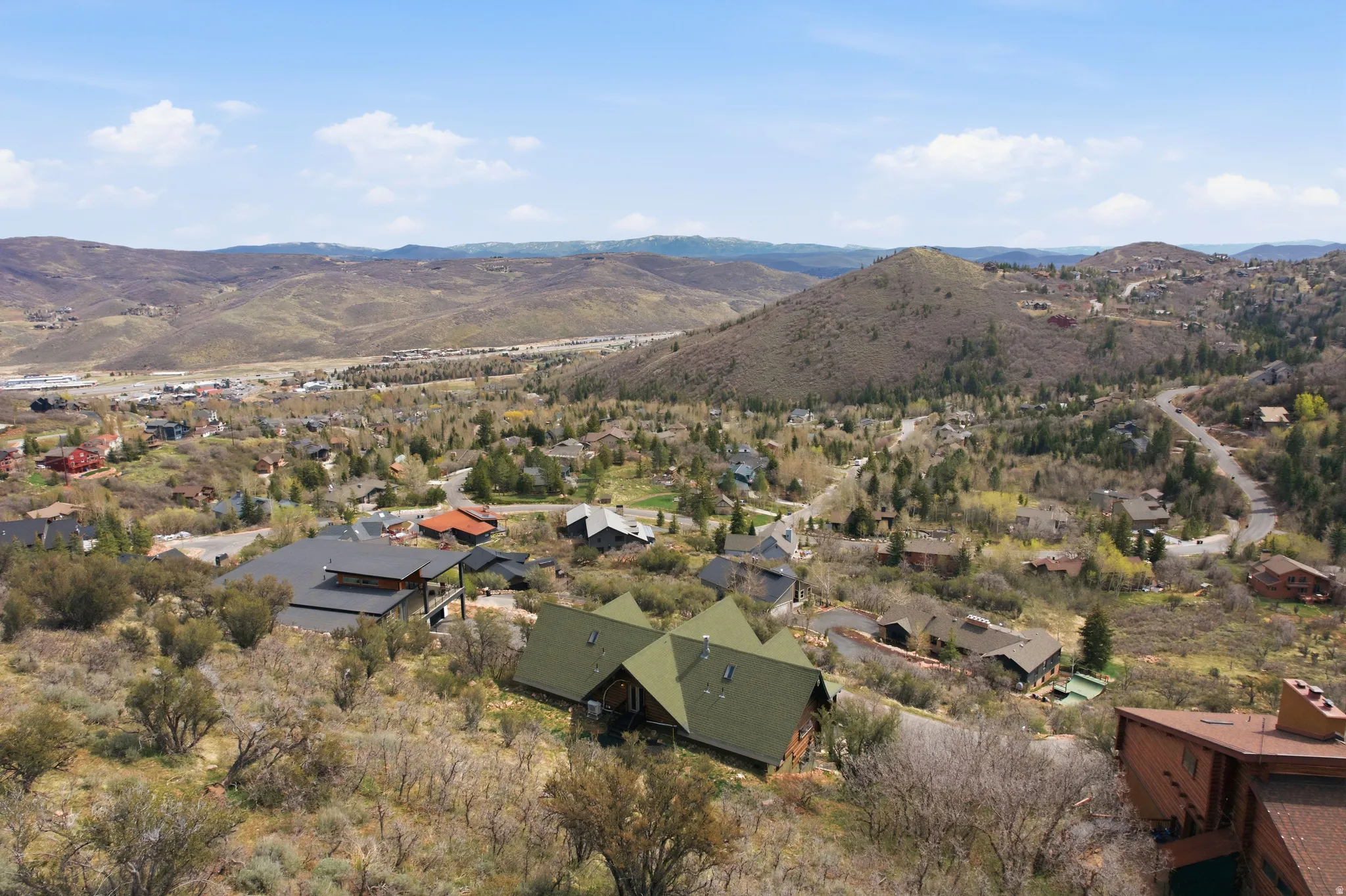 Aerial perspective of suburban area with a mountainous background