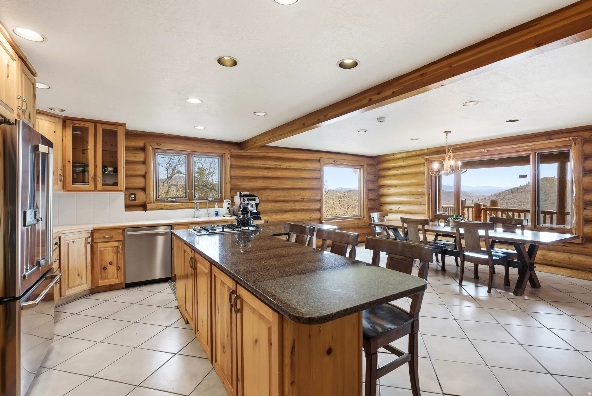 Kitchen featuring a kitchen bar, rustic walls, a kitchen island, stainless steel appliances, and wood finish cabinetry