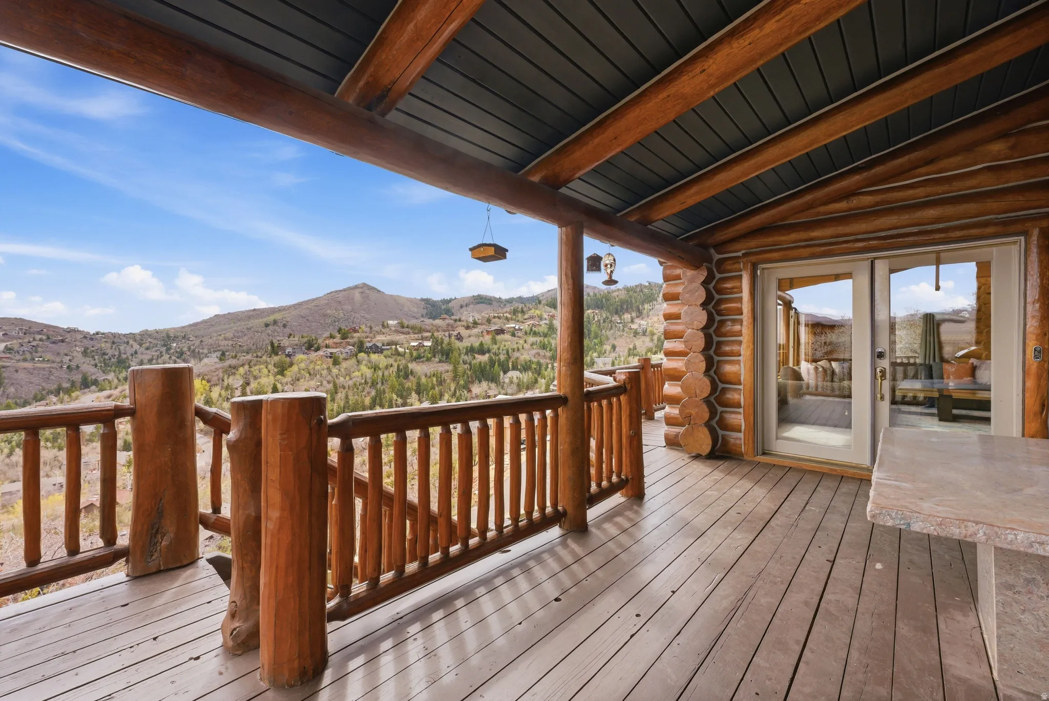 Wooden deck with a mountain view and french doors