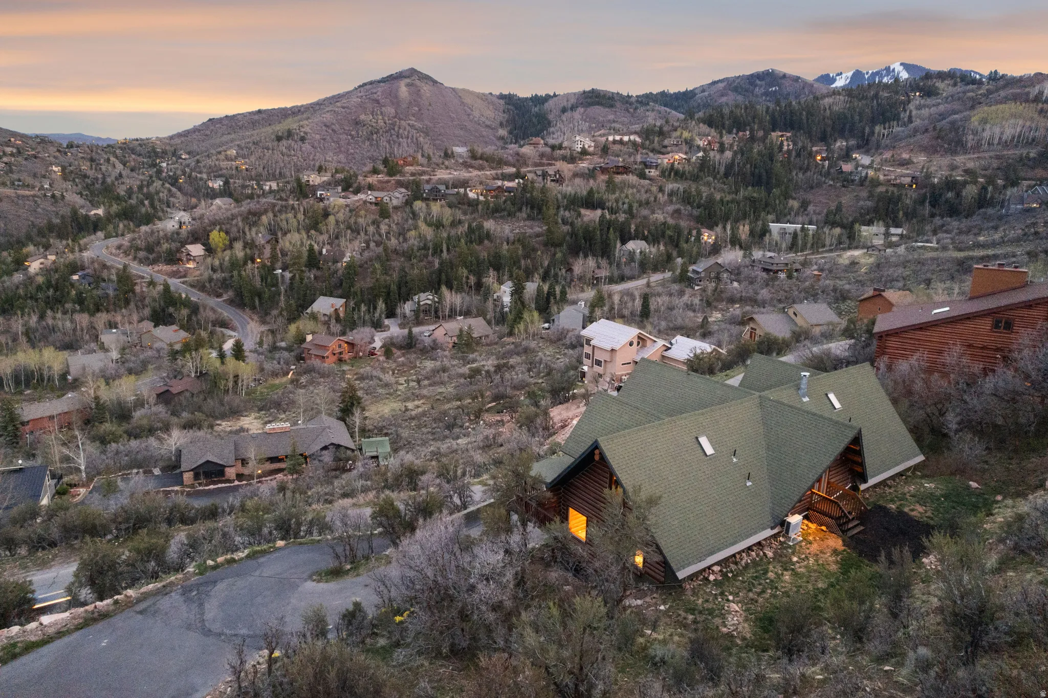 Aerial view of property and surrounding area with a mountain backdrop
