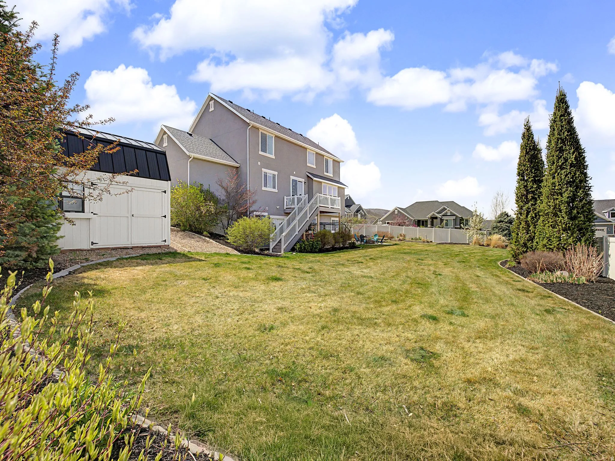 View of yard featuring a storage shed and a residential view