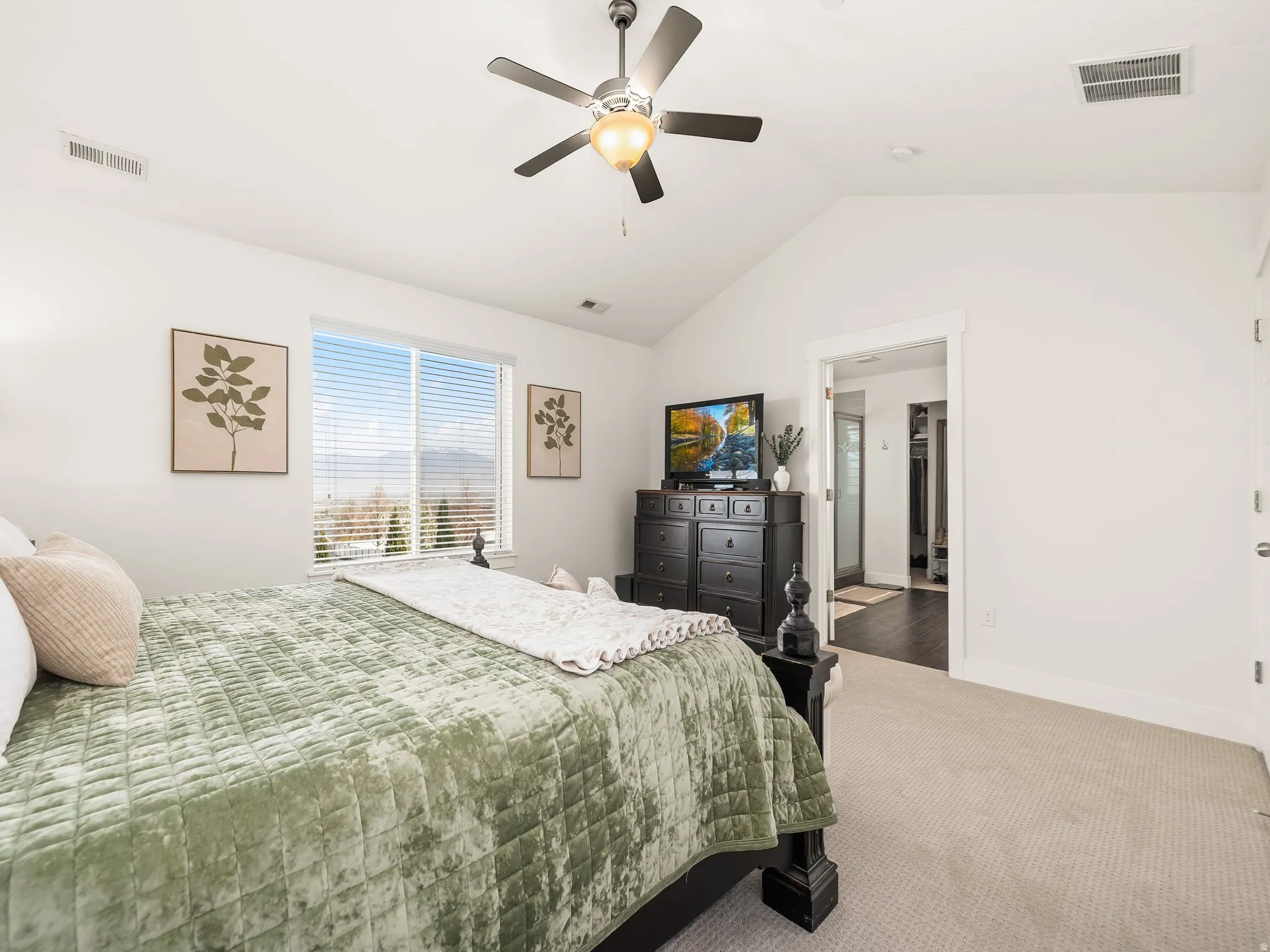 Carpeted bedroom with ceiling fan and baseboards