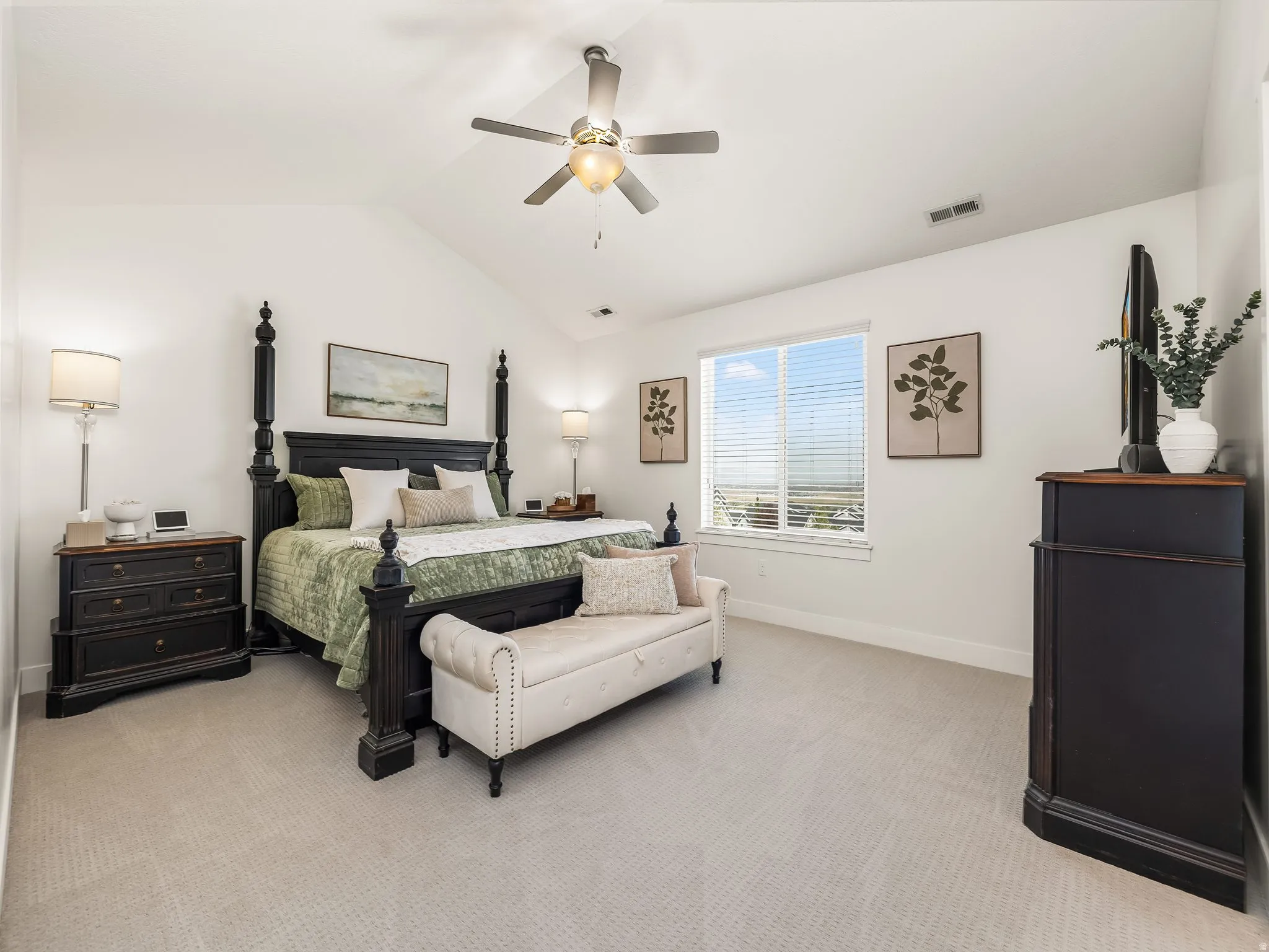 Bedroom featuring light carpet and a ceiling fan