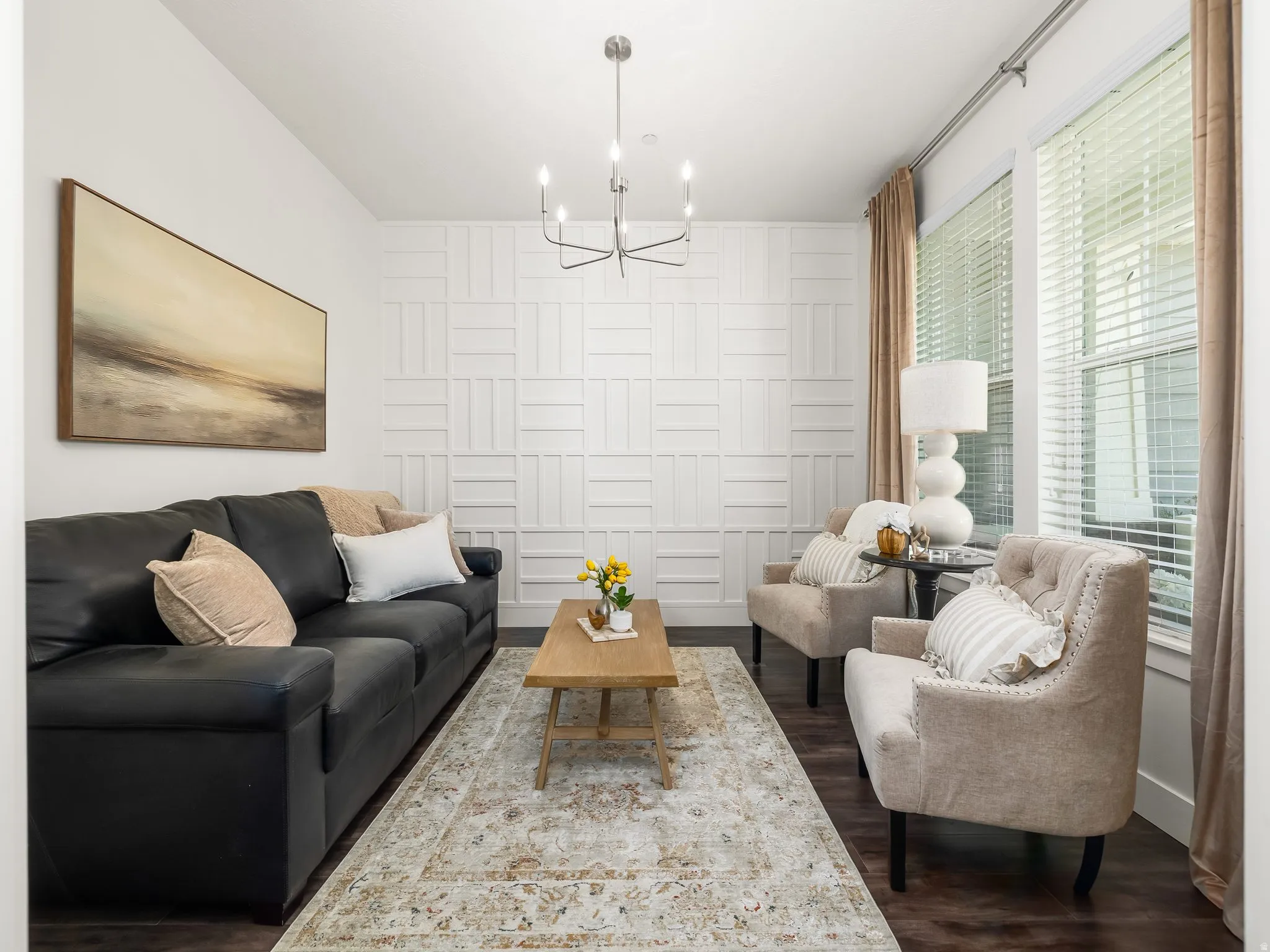 Living room featuring dark wood-style floors and suspended lighting