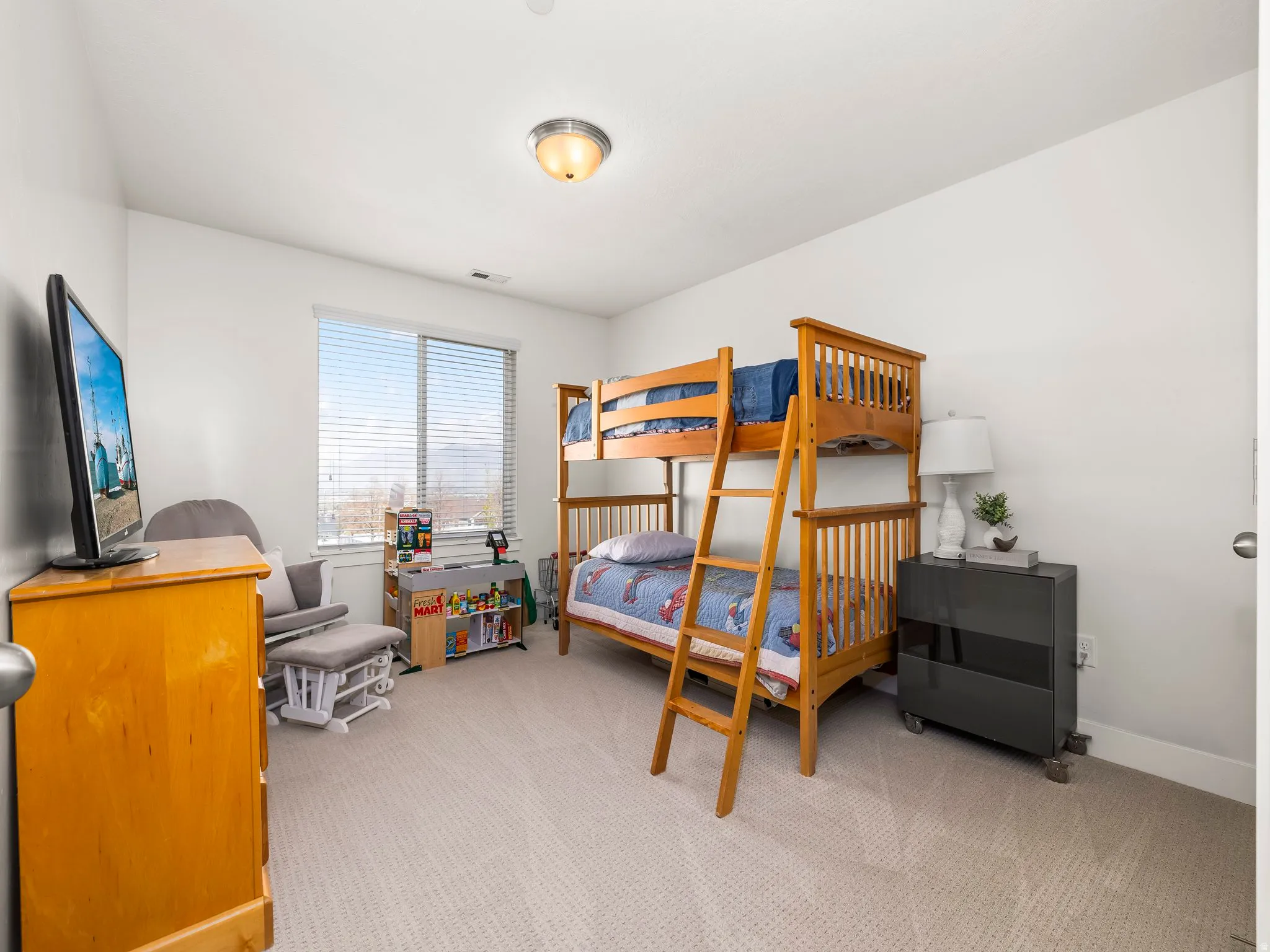 Bedroom with light colored carpet and baseboards