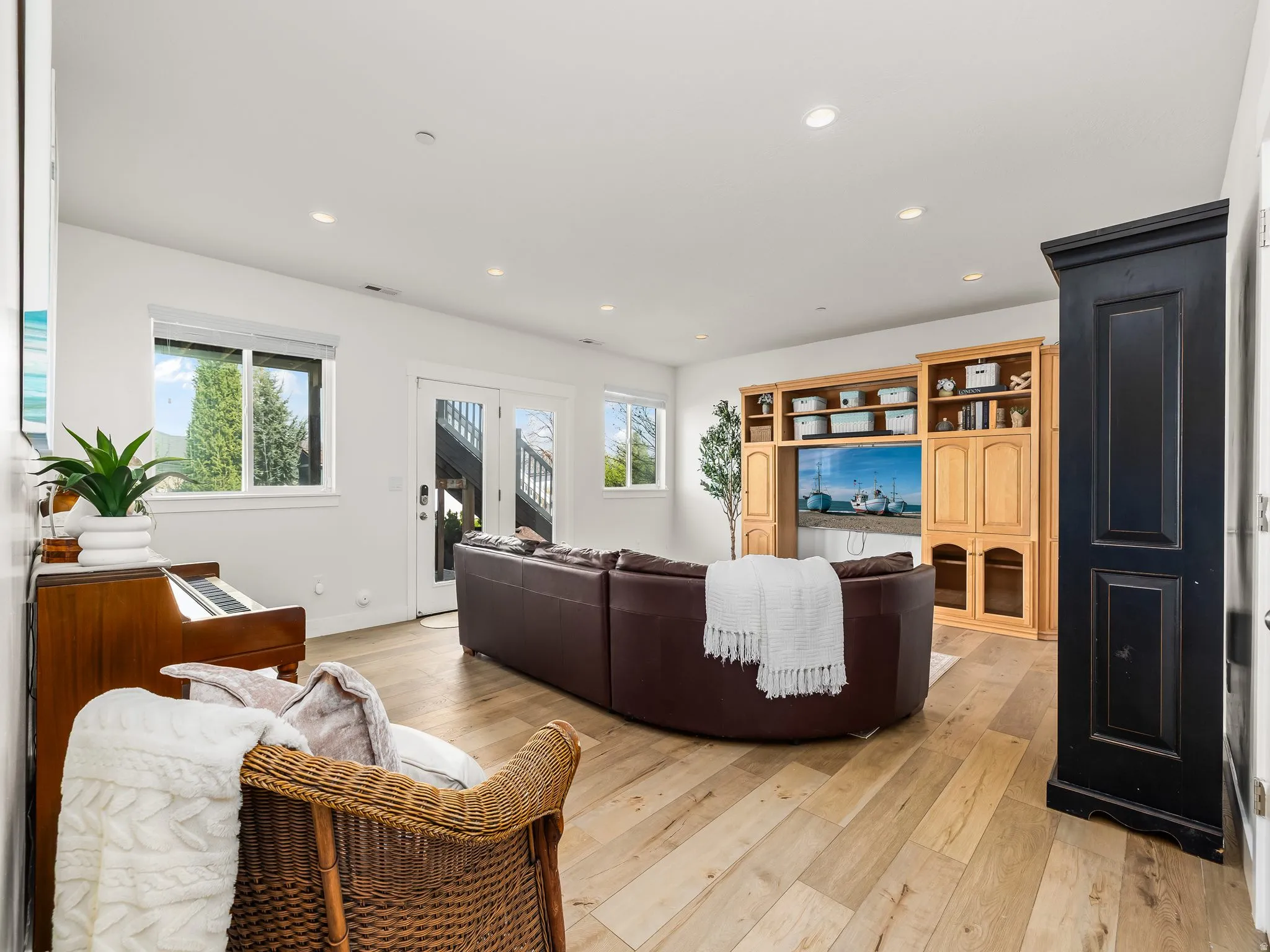 Living area featuring light wood-style floors and recessed lighting